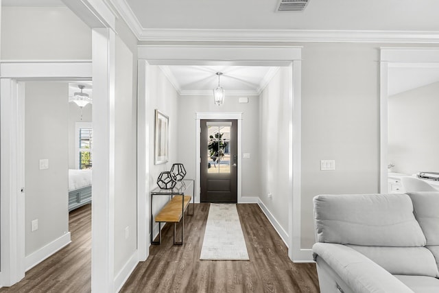 entryway with crown molding and dark hardwood / wood-style flooring