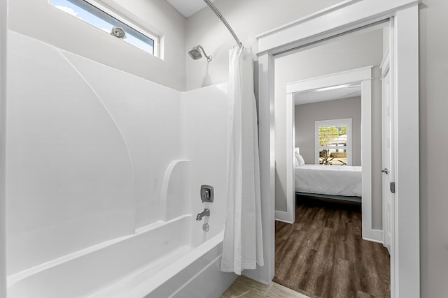 bathroom featuring shower / bath combo and wood-type flooring