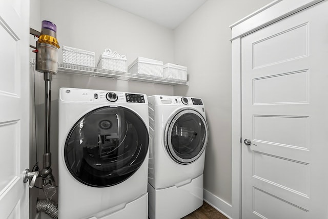 washroom featuring dark wood-type flooring and separate washer and dryer