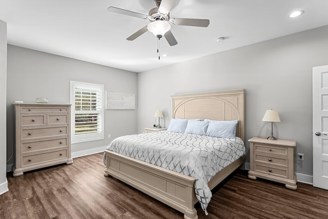 bedroom with dark hardwood / wood-style flooring and ceiling fan