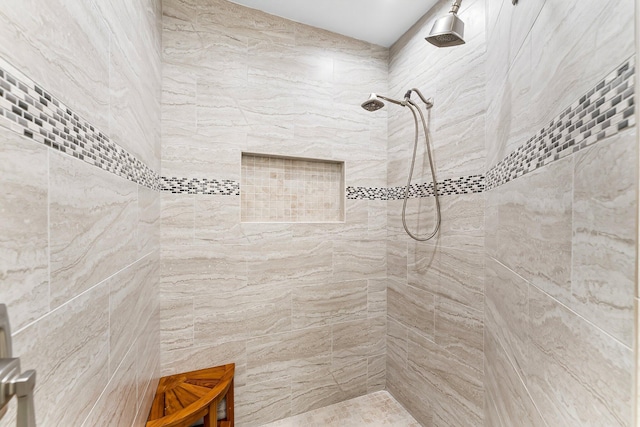 bathroom featuring a tile shower