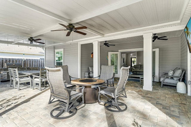 view of patio / terrace with ceiling fan and an outdoor fire pit