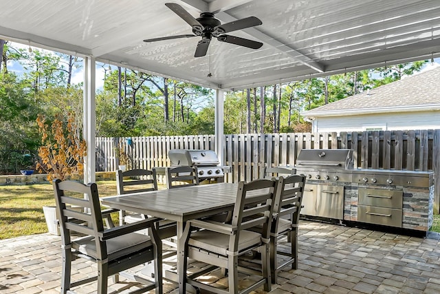 view of patio with grilling area, area for grilling, and ceiling fan