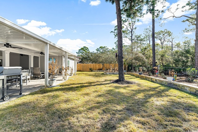 view of yard with ceiling fan and a patio area