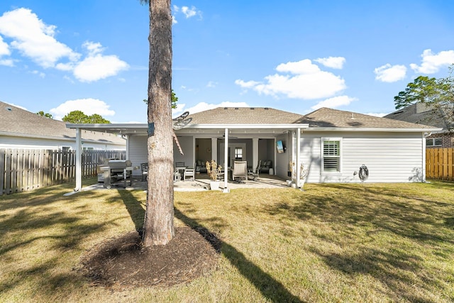 rear view of house with a yard and a patio