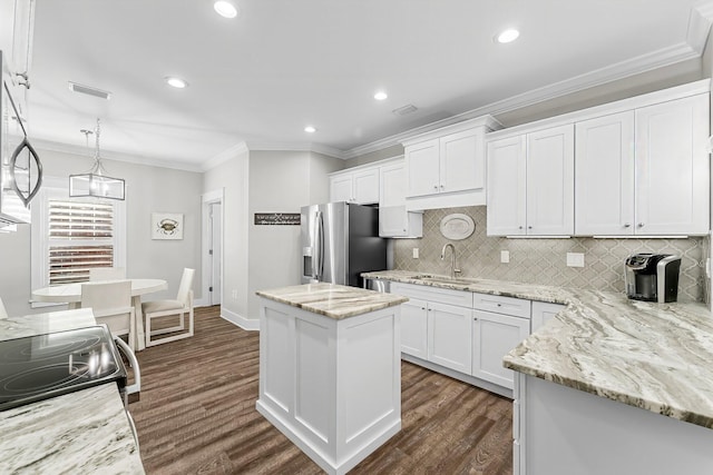 kitchen with sink, white cabinetry, hanging light fixtures, a center island, and stainless steel refrigerator with ice dispenser