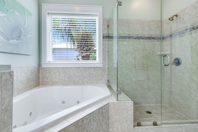 bathroom featuring shower with separate bathtub