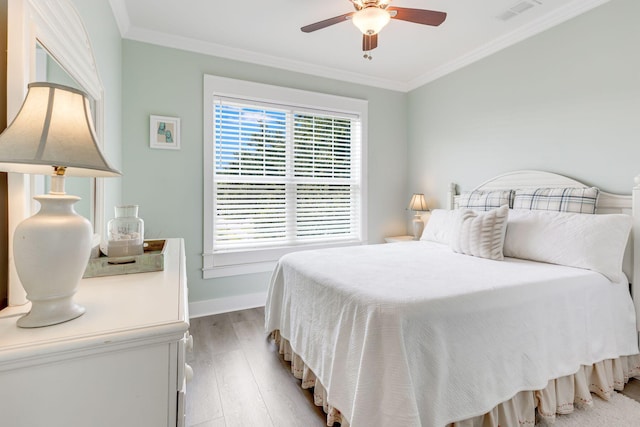 bedroom with ornamental molding, ceiling fan, and light hardwood / wood-style floors