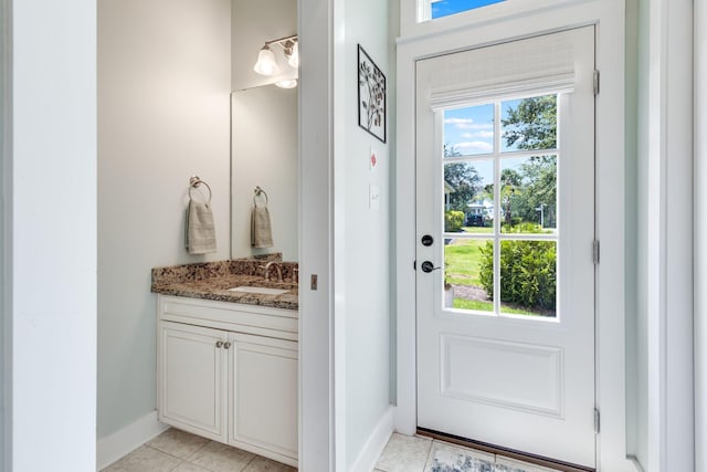 entryway with sink and light tile patterned floors