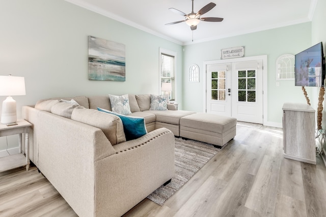 living room with crown molding, ceiling fan, light hardwood / wood-style floors, and french doors