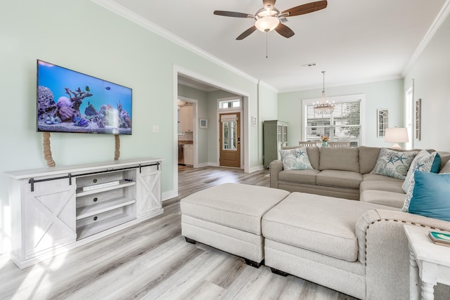 living room featuring ceiling fan with notable chandelier, light hardwood / wood-style flooring, and ornamental molding