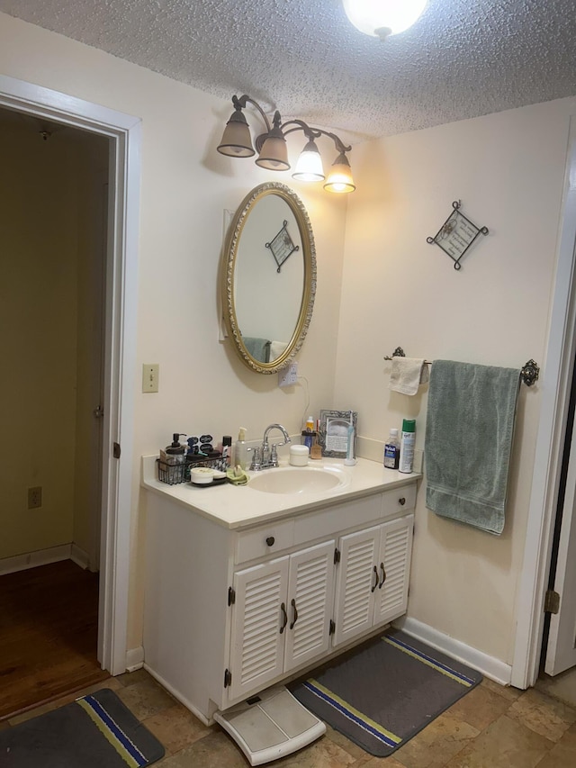 bathroom with vanity and a textured ceiling