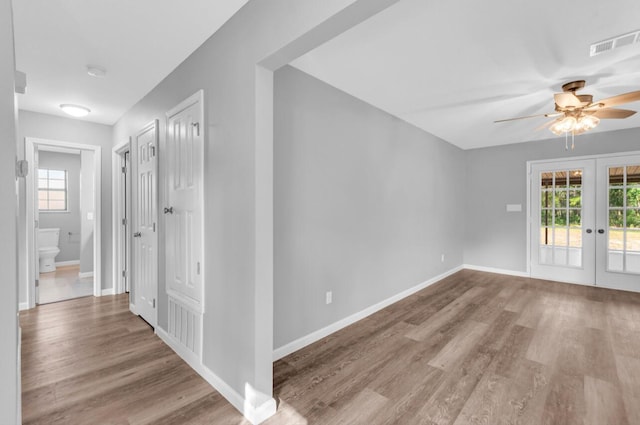 interior space with french doors, ceiling fan, and light hardwood / wood-style flooring