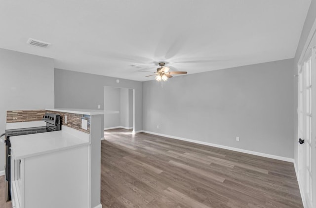 unfurnished living room with ceiling fan and light hardwood / wood-style flooring