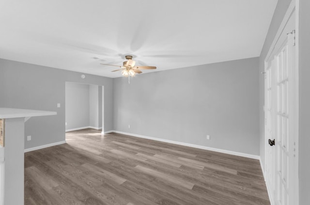 unfurnished living room featuring hardwood / wood-style flooring and ceiling fan