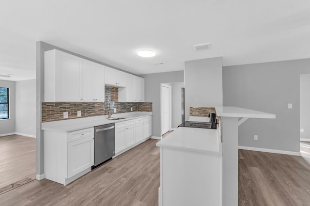 kitchen with white cabinetry, dishwasher, sink, backsplash, and light hardwood / wood-style floors