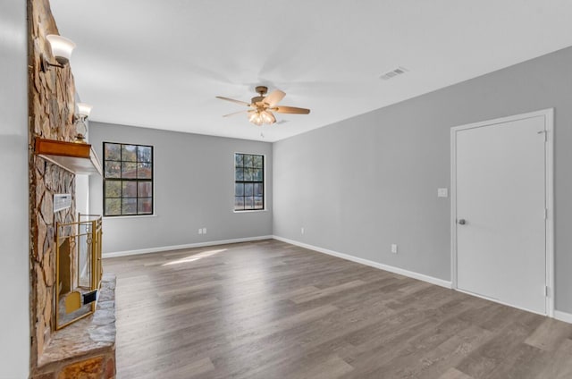 unfurnished living room with hardwood / wood-style floors and ceiling fan