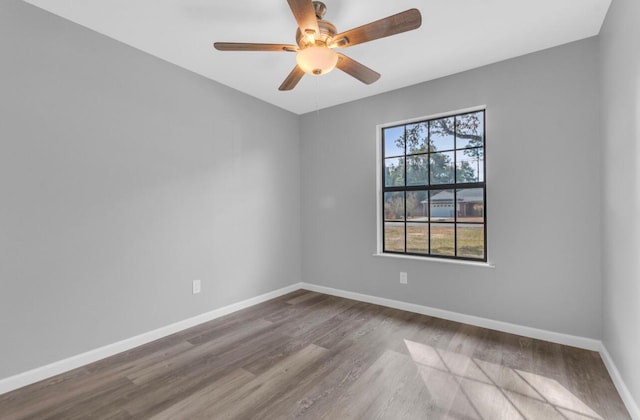 empty room featuring hardwood / wood-style floors and ceiling fan