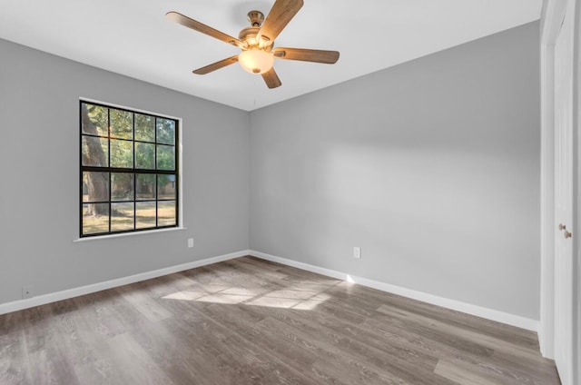 empty room featuring wood-type flooring and ceiling fan