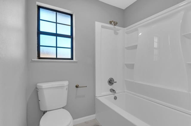 bathroom with tub / shower combination and toilet