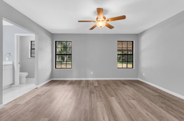 unfurnished room with ceiling fan, a healthy amount of sunlight, and light hardwood / wood-style floors