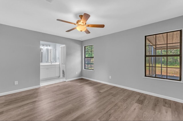 unfurnished room featuring ceiling fan and wood-type flooring