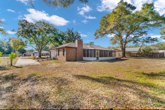 view of property exterior featuring a yard and a sunroom