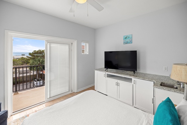 bedroom featuring access to outside, baseboards, multiple windows, and light wood finished floors