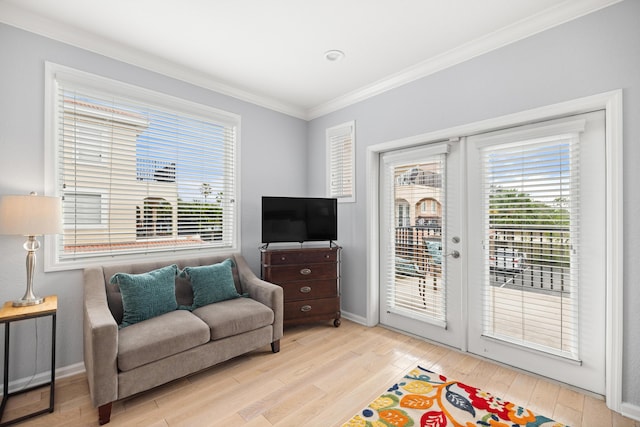 living area featuring light wood-type flooring, baseboards, ornamental molding, and french doors