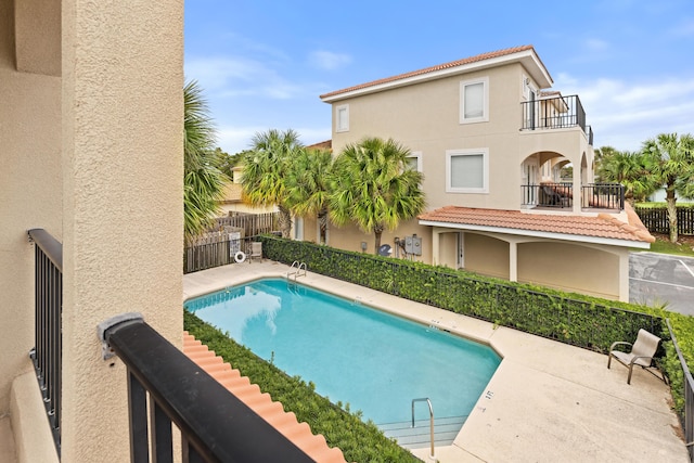 view of pool featuring a patio area, fence, and a fenced in pool