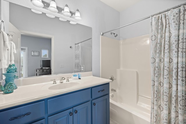 bathroom featuring shower / bath combo with shower curtain and vanity