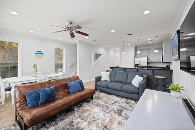 living room featuring stairs, ornamental molding, and light tile patterned floors