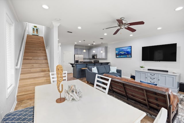 dining space with recessed lighting, visible vents, a ceiling fan, a healthy amount of sunlight, and stairs