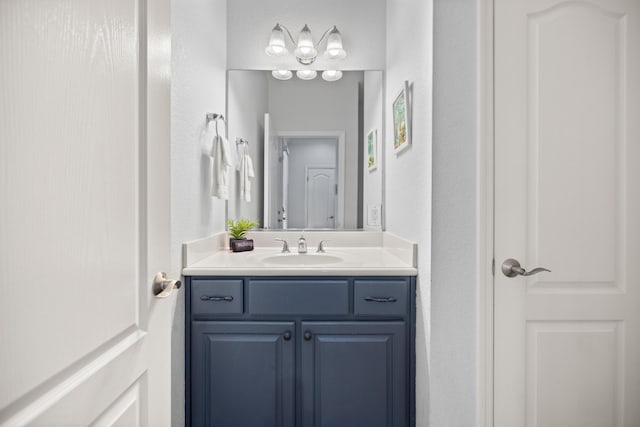 bathroom featuring a textured wall and vanity