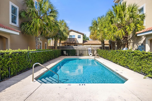 community pool featuring fence