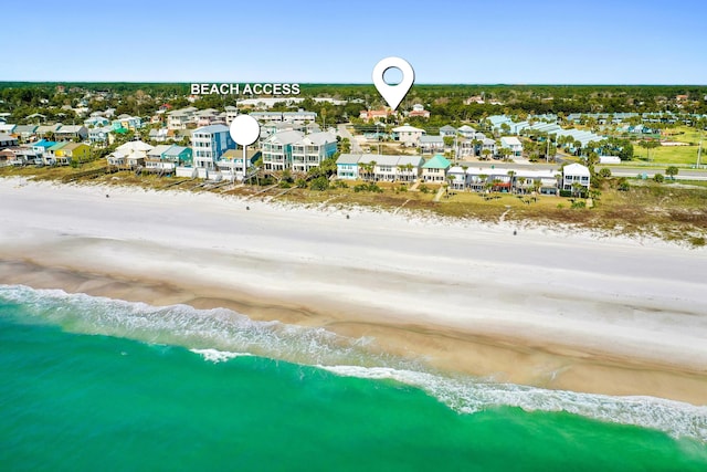 drone / aerial view with a water view, a residential view, and a view of the beach