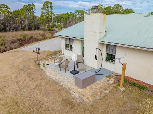 back of property featuring a patio