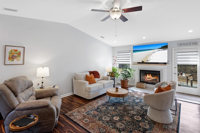 living room featuring vaulted ceiling, ceiling fan, and dark hardwood / wood-style flooring