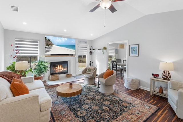 living room with lofted ceiling, dark wood-type flooring, and ceiling fan