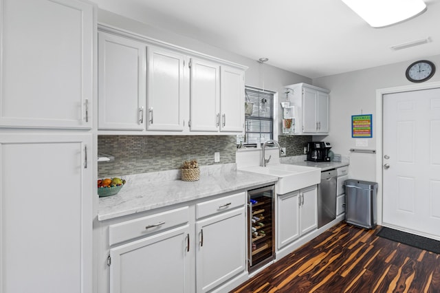 kitchen with wine cooler, sink, white cabinetry, dishwasher, and backsplash