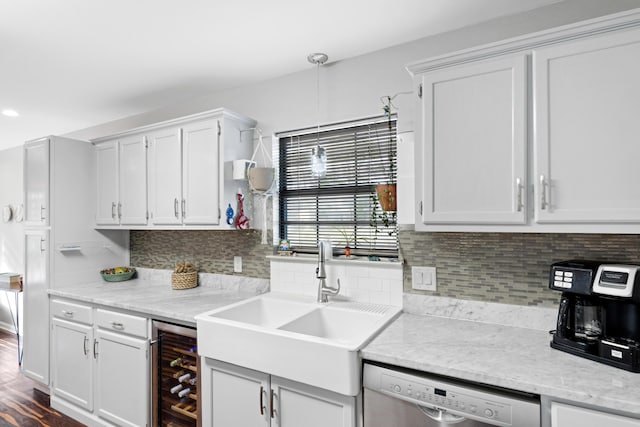 kitchen featuring tasteful backsplash, dishwasher, sink, white cabinets, and beverage cooler