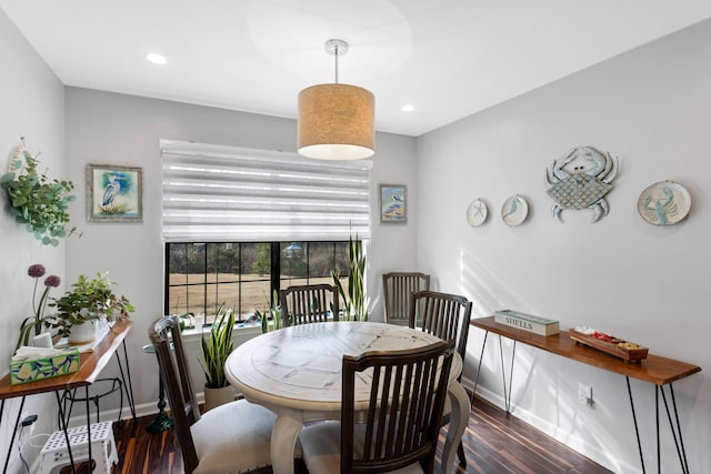 dining area with dark hardwood / wood-style flooring