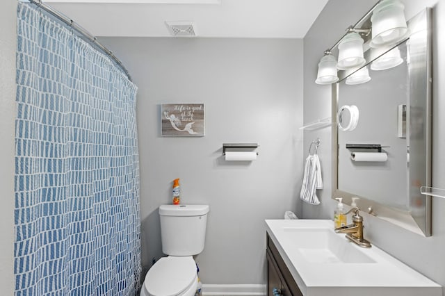 bathroom featuring vanity, curtained shower, and toilet