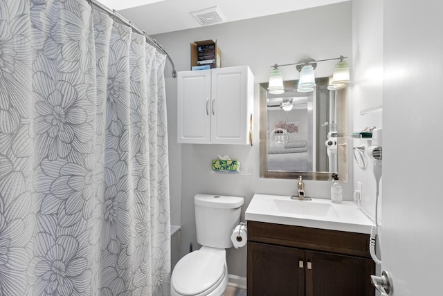 bathroom with vanity, curtained shower, and toilet