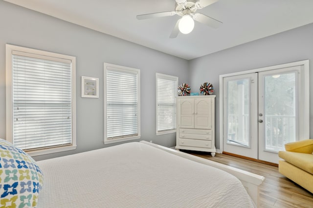 bedroom featuring multiple windows, access to outside, french doors, and light wood-type flooring