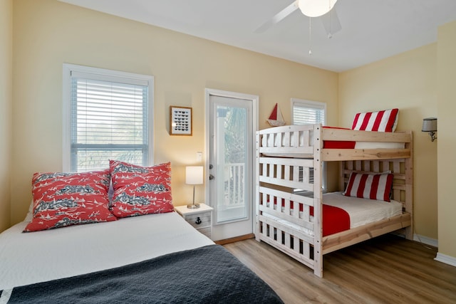 bedroom with hardwood / wood-style flooring, access to exterior, and ceiling fan