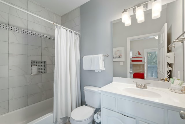 full bathroom featuring vanity, shower / bath combination with curtain, and toilet