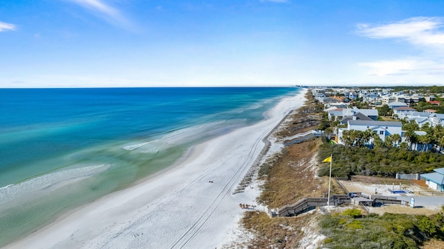 drone / aerial view featuring a water view and a view of the beach