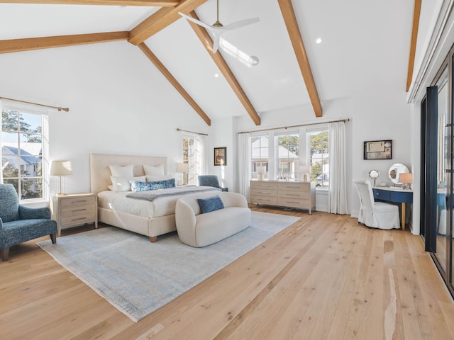 bedroom featuring beam ceiling, high vaulted ceiling, and light hardwood / wood-style flooring