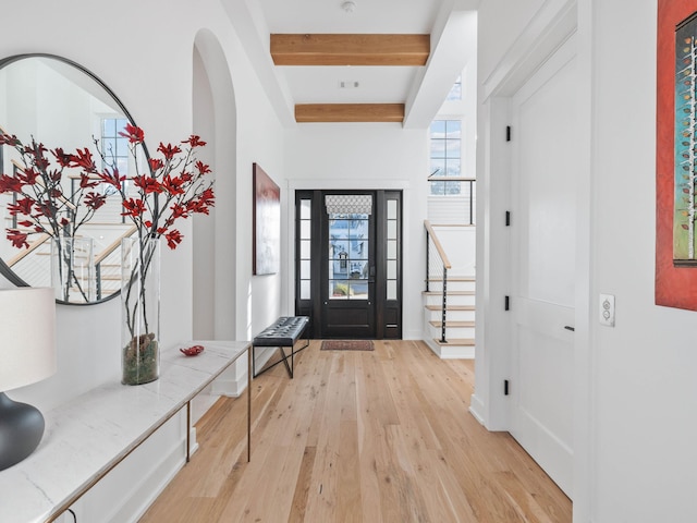 entrance foyer featuring beamed ceiling and light hardwood / wood-style floors